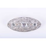 An Art Deco diamond and aquamarine broochof elongated oval form, the openwork mount set with rose-