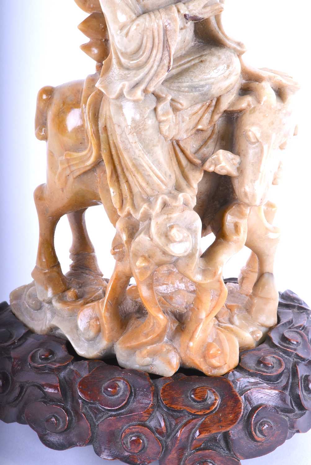 A Chinese carved soapstone figure of Guan Yin, late Qing, carved holding a vase and seated upon a - Image 3 of 4