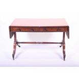 A Victorian mahogany sofa table with two drawers, on four swept feet, united by turned cross