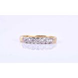 An 18ct yellow gold and diamond ringthe band collet-set with seven round brilliant-cut diamonds of