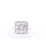 An 18ct white gold and diamond ringin the Art Deco taste, the squared mount cented with a mixed