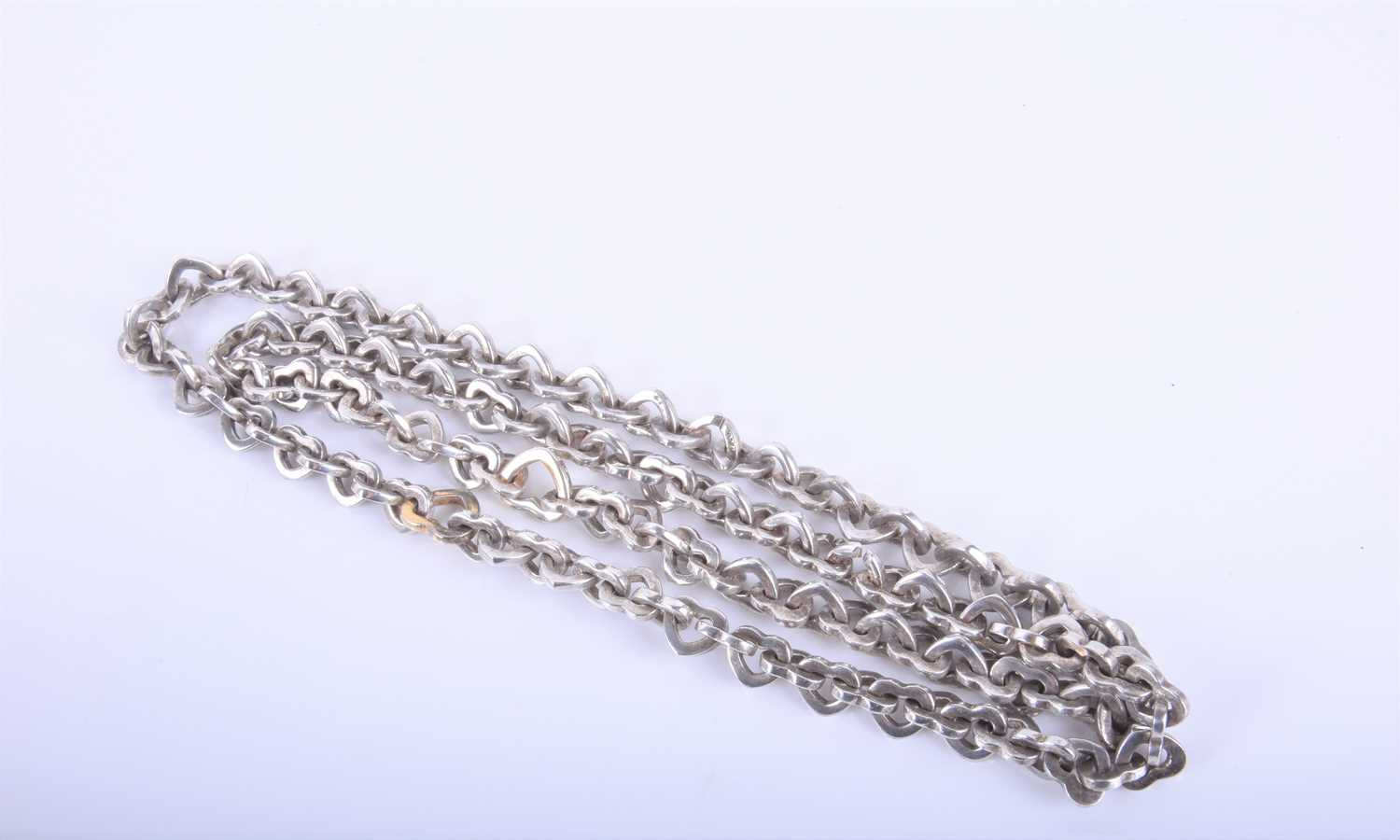 A Tiffany & Co love heart link white metal necklace with two larger gilded links, 43cm long,