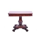 A 19th century mahogany fold-over card table, on octagonal baluster column and quatrefoil base,