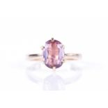 A 14k yellow gold and light purple/pink sapphire ringset with a mixed oval-cut sapphire (small