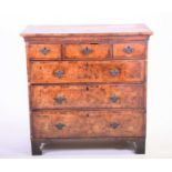 A George III walnut and inlaid veneer chest, with three narrow drawers over three graduated drawers,