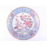 A Chinese dished plate, 20th century, decorated with a peacock and hen upon rocks, with blossoming