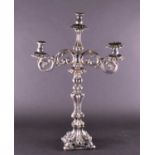 A large Continental white metal twin-branch hollowed candlestick, with scrolled arms and rococo