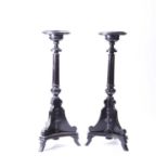 A pair of Victorian Aesthetic period ebonised torcheres, with gilt metal mounts and applied metal