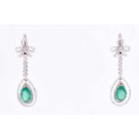 A fine pair of 18ct white gold, diamond, and Colombian emerald drop earringseach with a pear-cut
