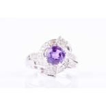 A diamond and amethyst cocktail ringthe stylised mount inset with a round-cut bright purple