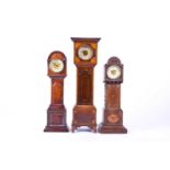 A group of three 19th-century apprentice/miniature longcase or grandfather clocks, two with