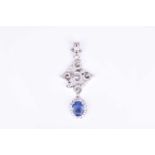 An impressive diamond and Sri Lanken sapphire pendantof stylised design the mount inset with round