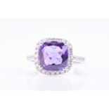 An 18ct white gold, diamond, and amethyst ringset with a square cushion-cut amethyst, surrounded