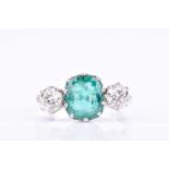 A diamond and emerald ringset with an oval cushion-cut emerald of approximately 3.0 carats,