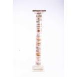 A 20th century agate pedestal stand, with square top, cylindrical column and stepped, square base,