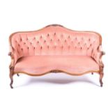 A Victorian walnut frame settee, with button-back plush upholstery, on carved scrolled cabriole