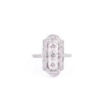 A diamond and platinum plaque ring in the Art Deco style, set with three round brilliant-cut