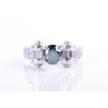 A 14k white gold and green diamond ring, set with a round brilliant-cut green diamond of