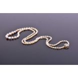 A natural saltwater and natural freshwater pearl necklacecomprised of graduated pearls in cream,