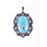 A white metal and turquoise pendant, set with an oval piece of turquoise (with pyrite inclusions and