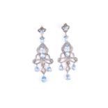 A pair of silver gilt, diamond, and blue stone chandelier drop earringsof impressive design, the