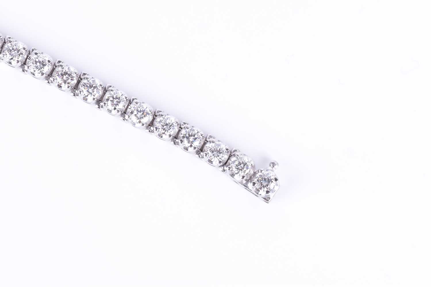 A fine quality 14ct white gold and diamond line bracelet, set with thirty round brilliant-cut - Image 6 of 9
