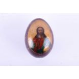 A 19th century Russian papier maché Easter Egg, with lacquer finish, depicting Christ in Majesty,