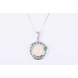 A 9ct white gold, emerald, and opal pendantof circular form, set with a round cabochon opal,