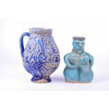 A Persian blue glazed calligraphic jug, possibly Kashan 15th century or later, relief moulded with