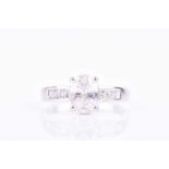 An 18ct white gold and diamond ringset with a mixed oval-cut diamond of approximately 1.22 carats,