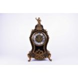 A Louis XV style French mantel clock, in an ebonised wood case with applied gilt brass decoration,