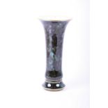A late 19th century Sevres porcelain tall vase of trumpet form, with marbled green decoration and