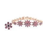 A gilt metal and garnet floral cluster bracelet formed of eighteen graduated clusters of garnets (