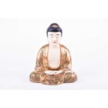 A Japanese satsuma figure of Amida Buddha, late Meiji, seated crossed legged, his hands in mida no