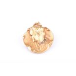 An Art Nouveau yellow gold and diamond broochof rounded form, depicting a beautiful young girl in