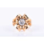 A French Art Deco gold and diamond ringthe stylised ribbon cluster mount of symmetrical design,