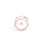A 14k yellow gold, diamond, and pearl ringcentred with a large cultured pearl approximately 13 mm