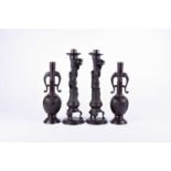 A pair of late 19th century Japanese patinated bronze candlesticks, modelled with a dragon twisted