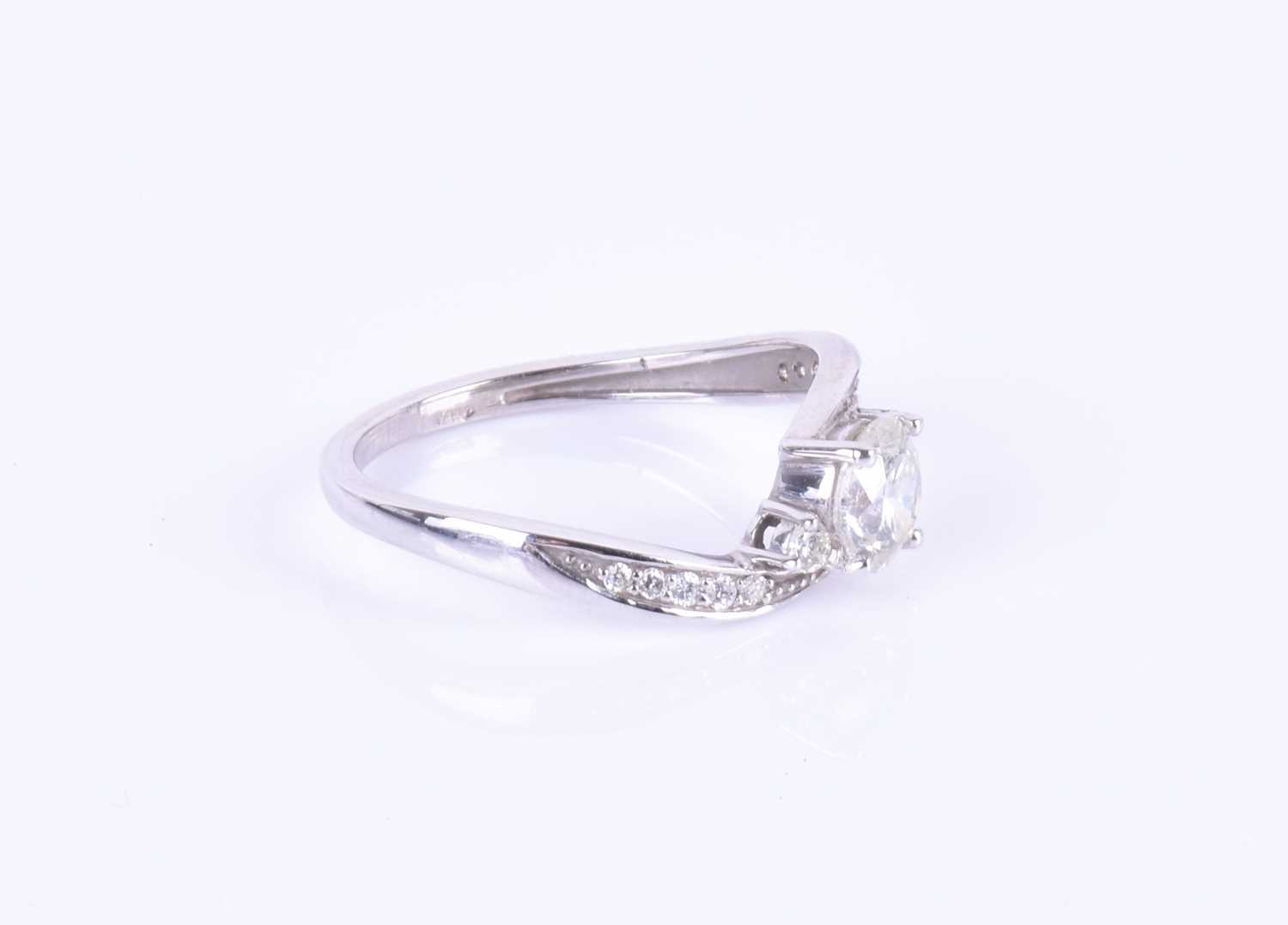 A 14ct white gold and diamond ring, centered with a round brilliant-cut diamond of approximately 0. - Image 2 of 7