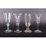 A group of four 18th century / early 19th century and later drinking glasses, of varying desgin, the