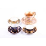 Two mid-19th century Vienna porcelain cabinet cups and saucers, of varying design, each with gilt