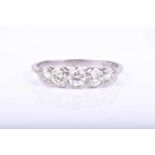 A platinum and diamond ringmillegrain set with five graduated round-cut diamonds of approximately