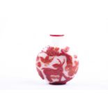 A Chinese Peking glass snuff bottle, Qing dynasty, with red glass overlaid onto white, one side