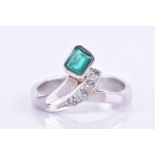 A 14ct white gold, diamond, and emerald wishbone ringset with an emerald-cut emerald and four