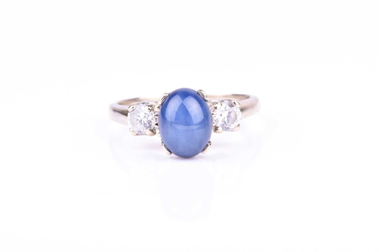 A 14k white gold, star sapphire, and CZ ringset with an oval star sapphire flanked with two round-