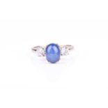 A 14k white gold, star sapphire, and CZ ringset with an oval star sapphire flanked with two round-