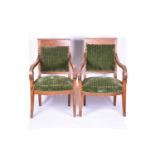A pair of Regency style walnut armchairs, with scroll arms and green upholstery, 90 cm high x 59