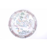 A Chinese porcelain charger, early 20th century, painted with figures playing go, whilst a lady