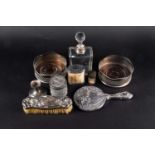 A small collection of silver comprising, a pair of wine coasters, two silver topped dressing table