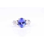 A diamond and tanzanite ringset with a mixed oval-cut tanzanite of approximately 2.82 carats,